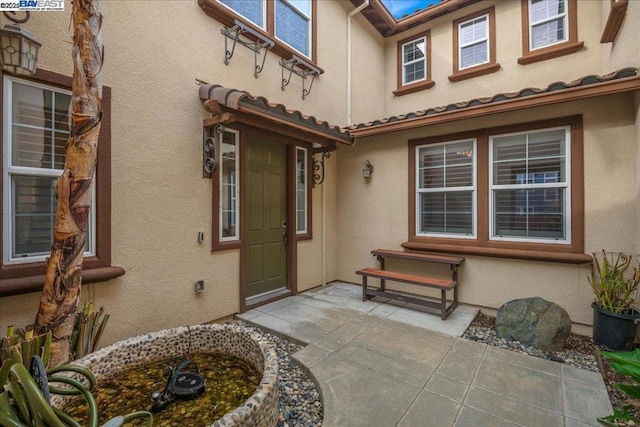 doorway to property with a patio