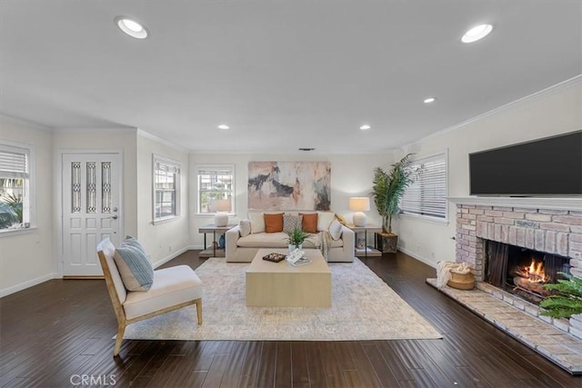 living room featuring dark hardwood / wood-style flooring, a brick fireplace, and ornamental molding