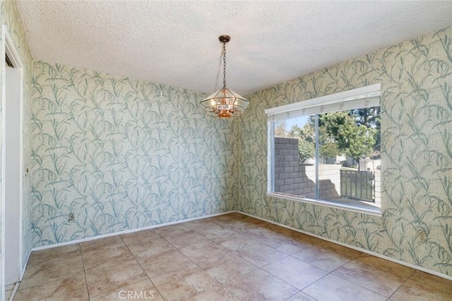 unfurnished dining area with a textured ceiling