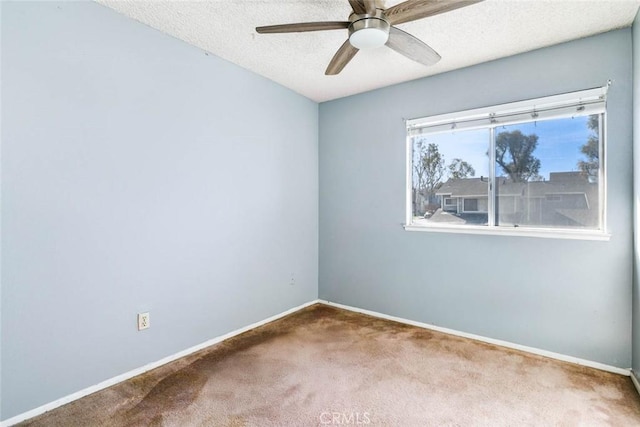 carpeted empty room with a textured ceiling and ceiling fan