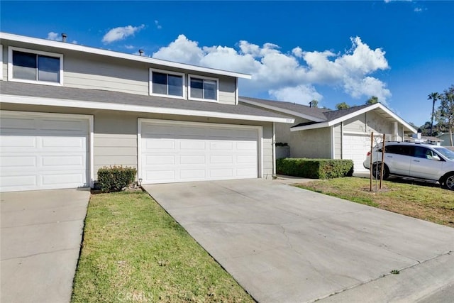 view of front facade with a garage and a front lawn