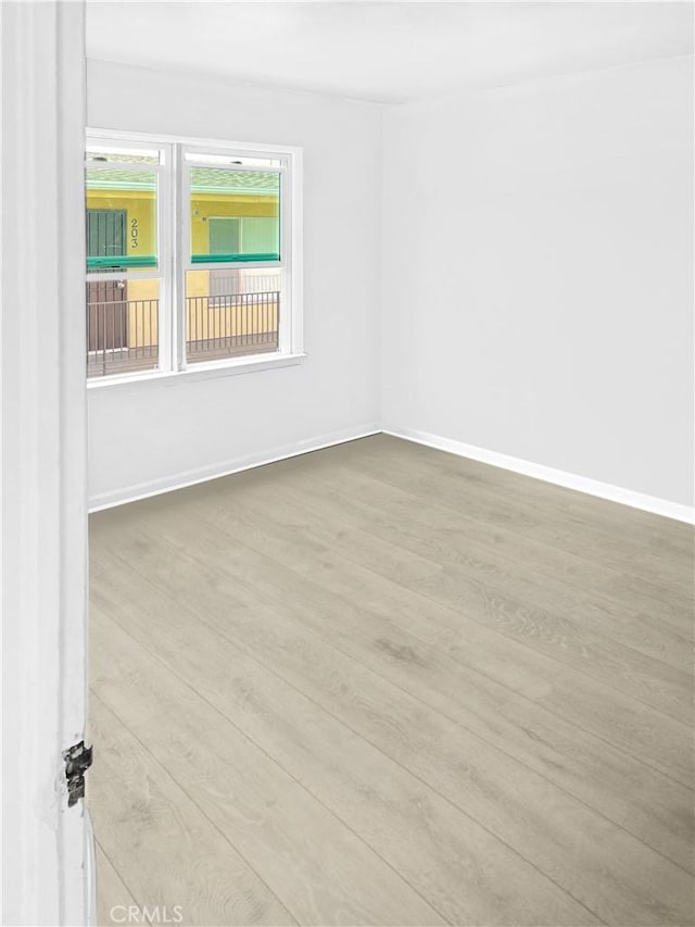 spare room featuring light wood-type flooring