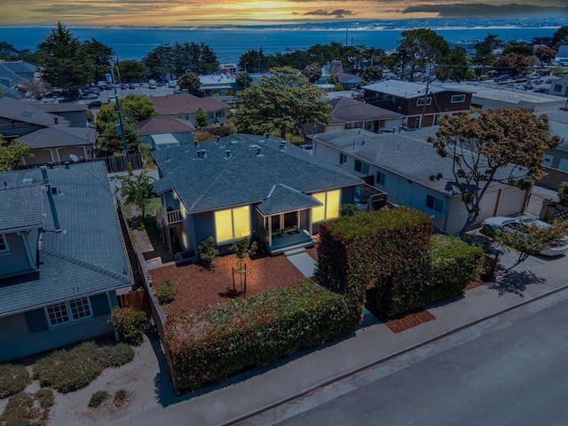 aerial view at dusk with a water view