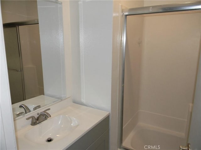 bathroom with vanity and enclosed tub / shower combo