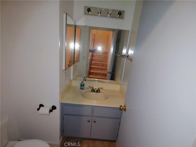 bathroom featuring vanity and toilet