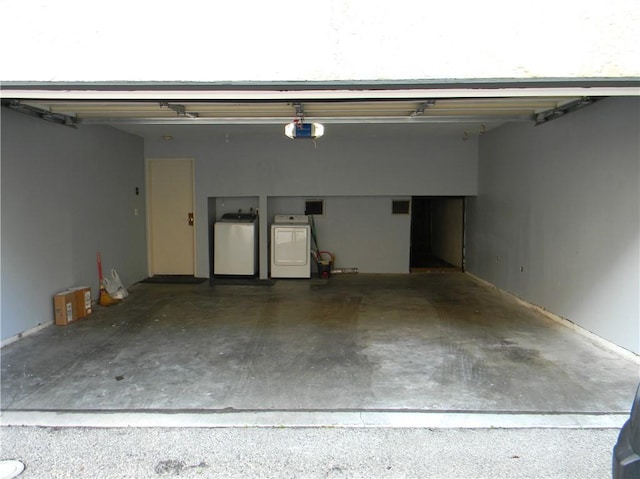 garage featuring a garage door opener and washing machine and dryer