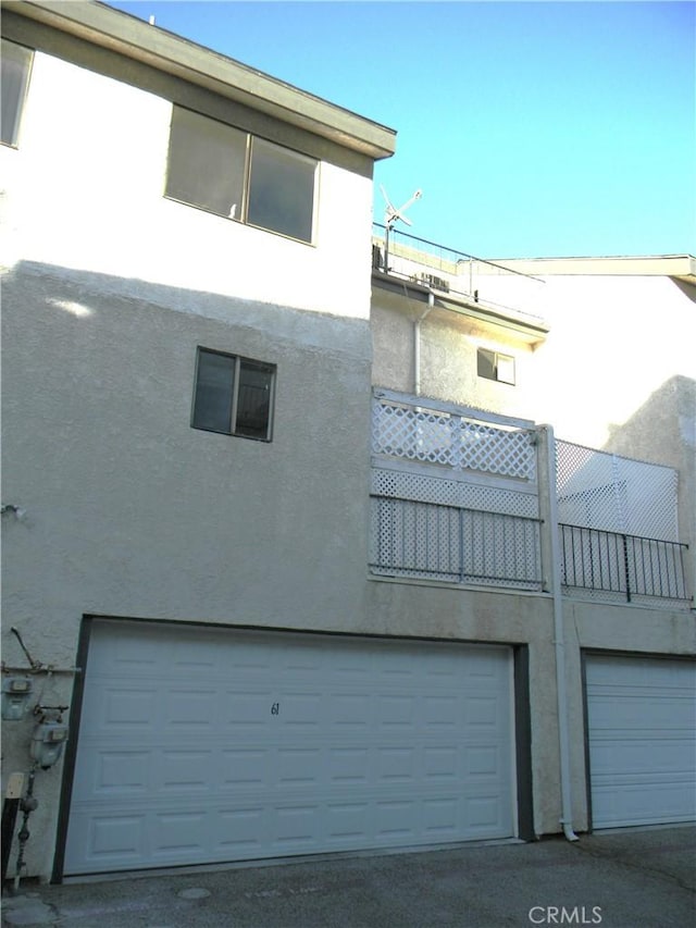 back of house featuring a garage