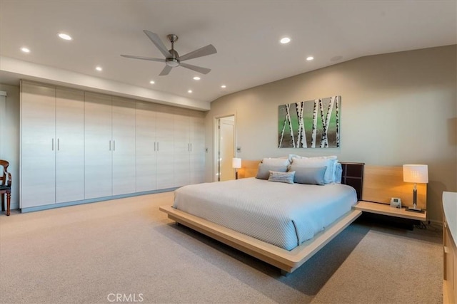 bedroom with ceiling fan and light carpet