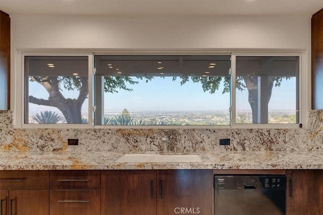 room details featuring dishwasher, light stone countertops, and sink