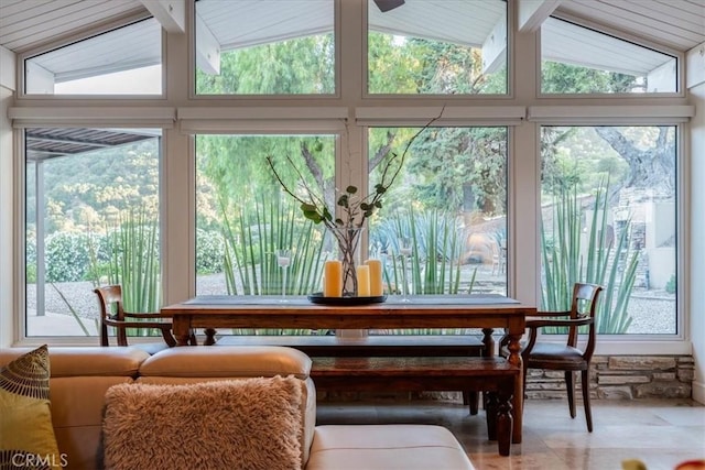 sunroom / solarium featuring lofted ceiling with beams