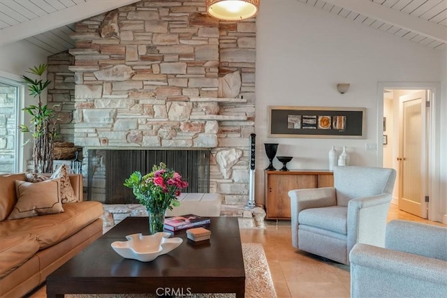 living room with wooden ceiling, a stone fireplace, and vaulted ceiling with beams