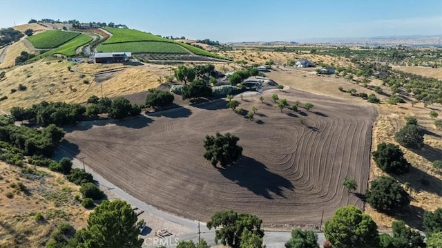 birds eye view of property with a rural view