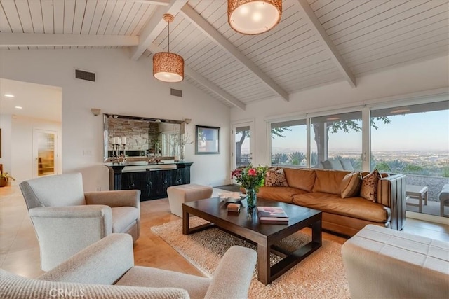 tiled living room featuring beam ceiling and high vaulted ceiling