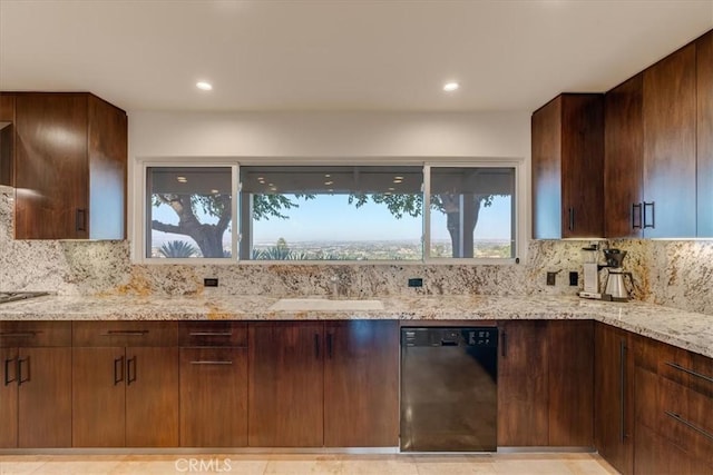 kitchen with tasteful backsplash, light stone countertops, sink, and black appliances