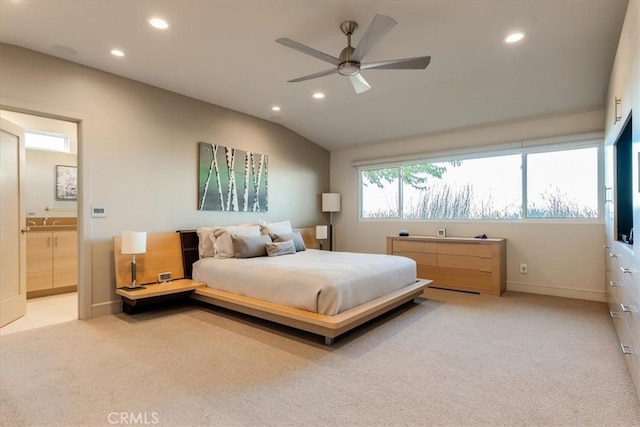 bedroom with ceiling fan, lofted ceiling, light colored carpet, and ensuite bath