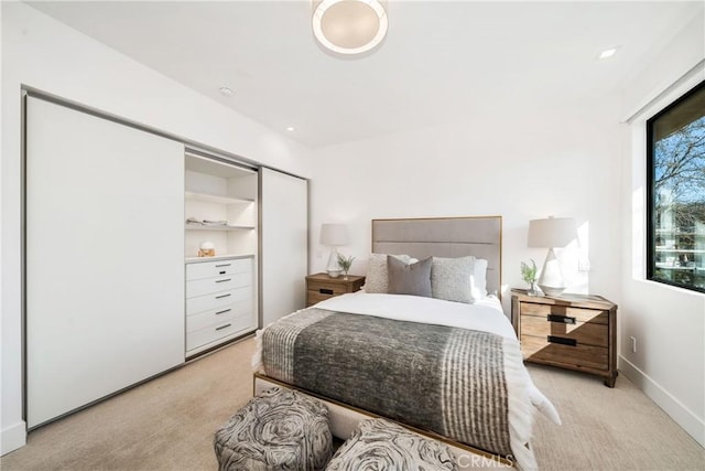 bedroom featuring light carpet and baseboards