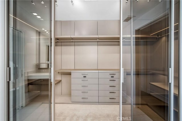 walk in closet with tile patterned floors