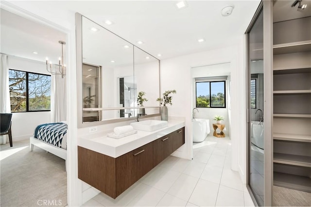1223 Roxbury Dr Unit 202, Los Angeles, CA 90035 - bathroom featuring a freestanding bath, vanity, plenty of natural light, a chandelier, and recessed lighting