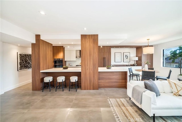 living area featuring light tile patterned floors and recessed lighting