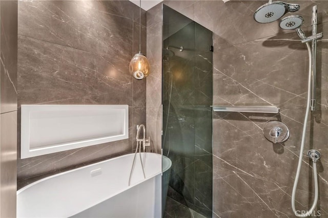 full bath featuring a soaking tub, a shower, and tile walls