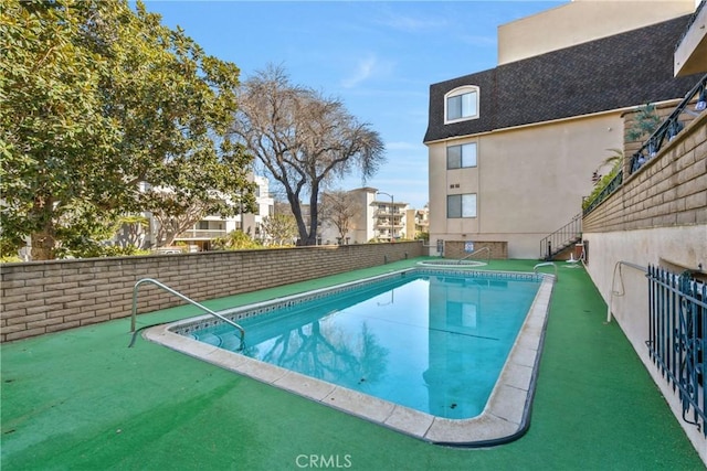 view of swimming pool with fence and a fenced in pool