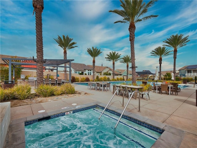 view of swimming pool with a community hot tub, a pergola, and a patio