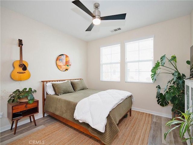 bedroom featuring hardwood / wood-style floors and ceiling fan