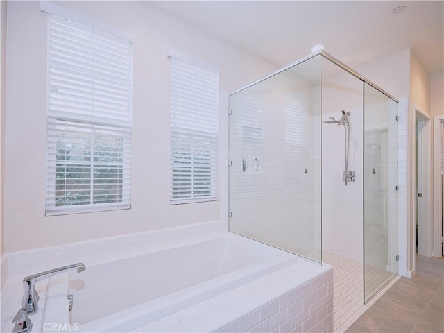 bathroom featuring tile patterned floors and independent shower and bath