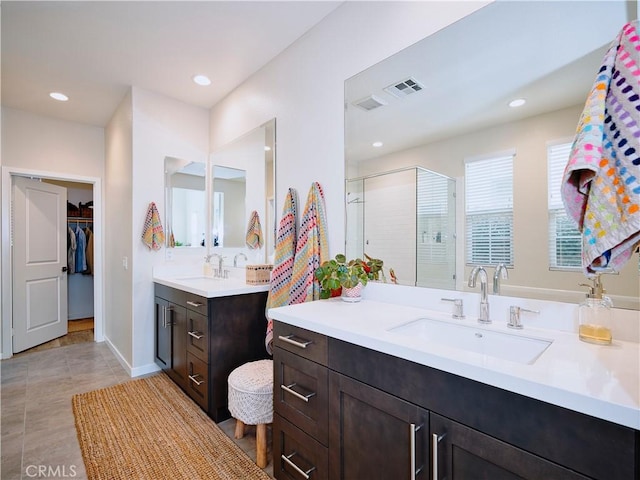 bathroom featuring vanity and a shower with door