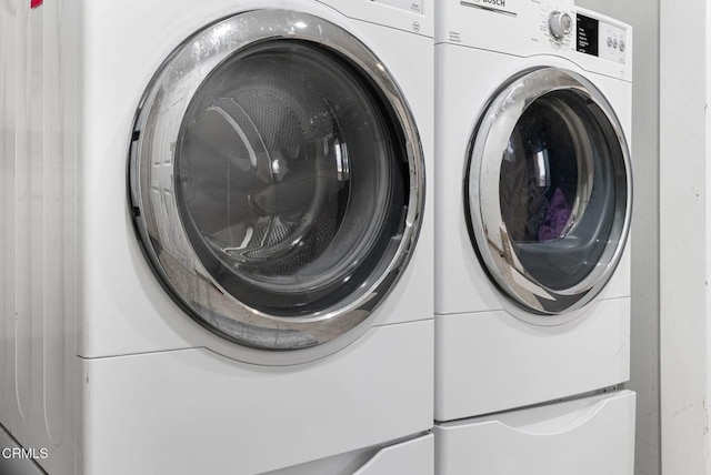 clothes washing area featuring washer and clothes dryer