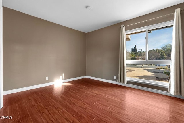 unfurnished room with hardwood / wood-style floors