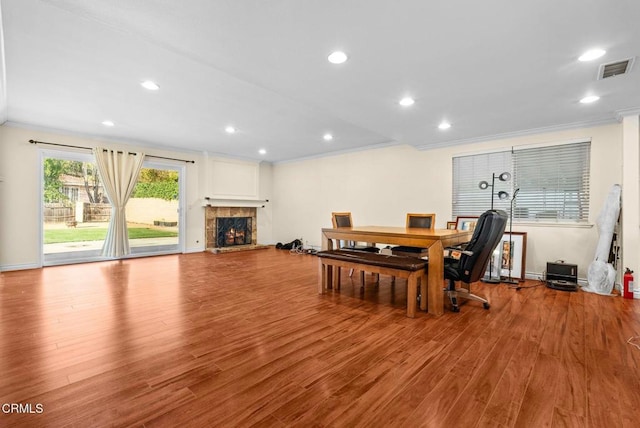 dining space featuring crown molding and light wood-type flooring