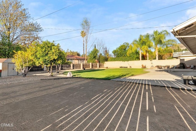 view of parking / parking lot featuring a lawn