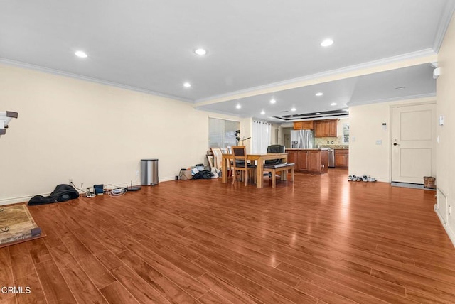 interior space with crown molding and light hardwood / wood-style flooring