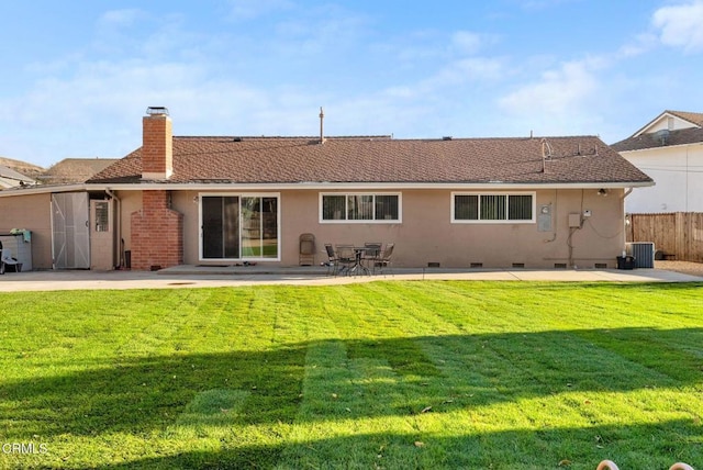 rear view of property featuring cooling unit, a yard, and a patio area