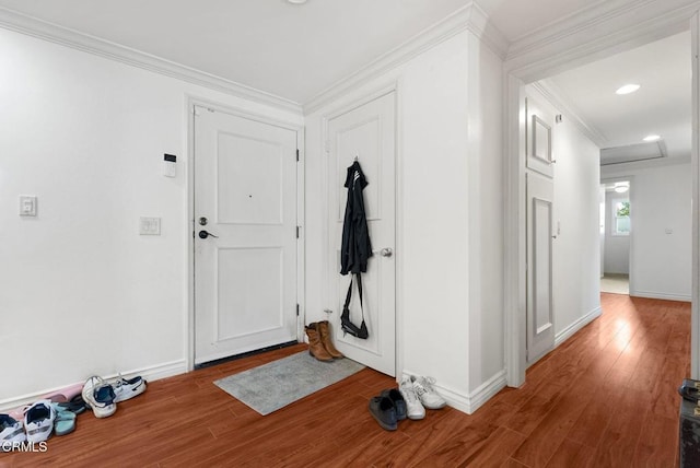 entryway featuring hardwood / wood-style flooring and crown molding