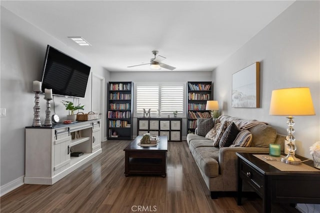 living room with dark wood-type flooring and ceiling fan