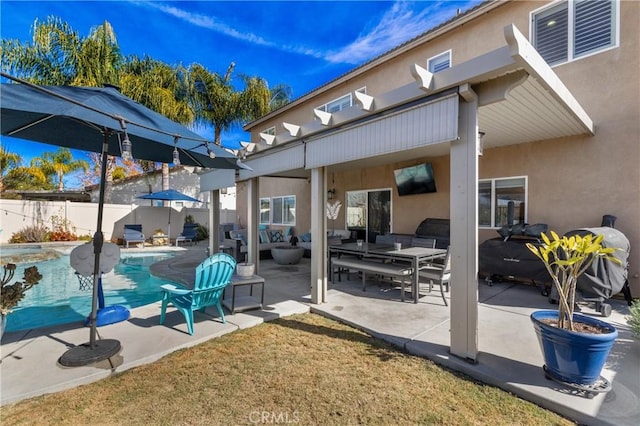 view of patio with an outdoor living space and a fenced in pool