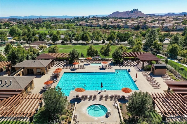 view of pool with a mountain view, a pergola, a community hot tub, and a patio