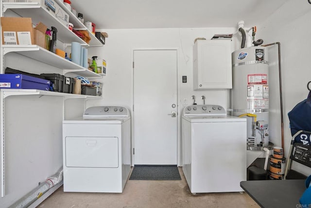 laundry area featuring water heater and washer and dryer