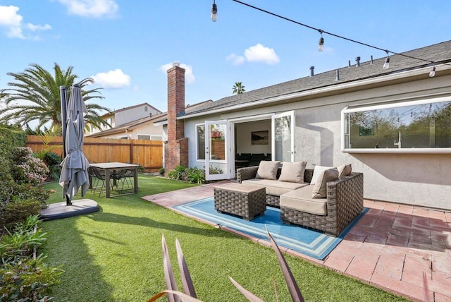 rear view of house featuring a patio, an outdoor hangout area, and a lawn