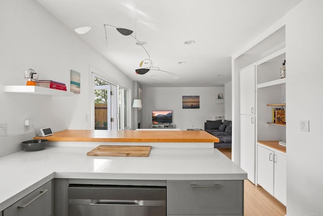 kitchen featuring gray cabinetry, kitchen peninsula, and light wood-type flooring