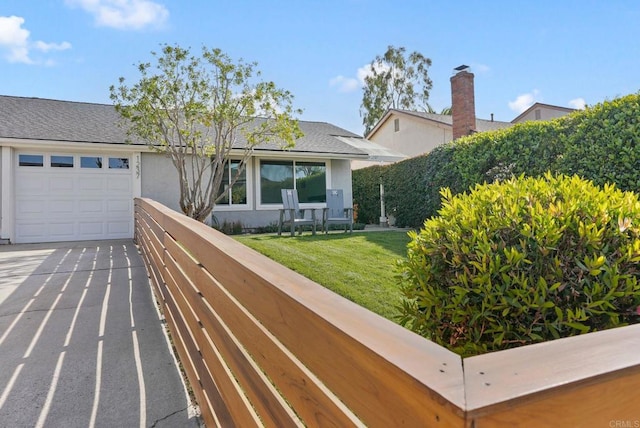 view of front of house with a garage and a front yard