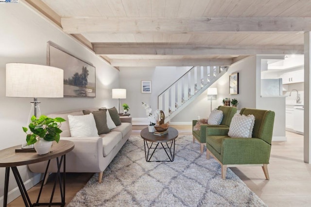 living room with wooden ceiling, beamed ceiling, and light wood-type flooring