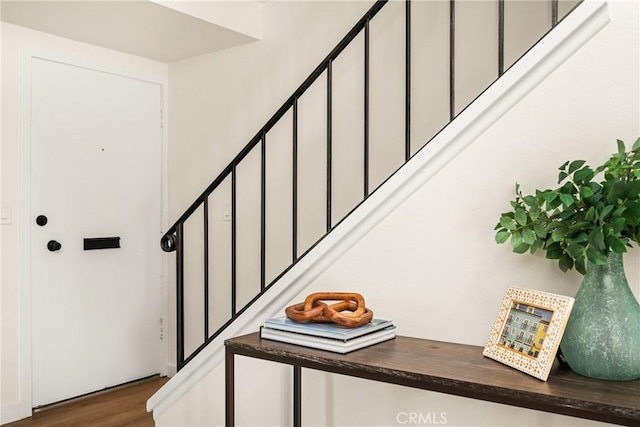 stairs featuring wood finished floors