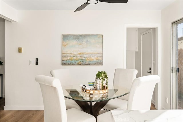 dining area with wood finished floors, baseboards, and ceiling fan