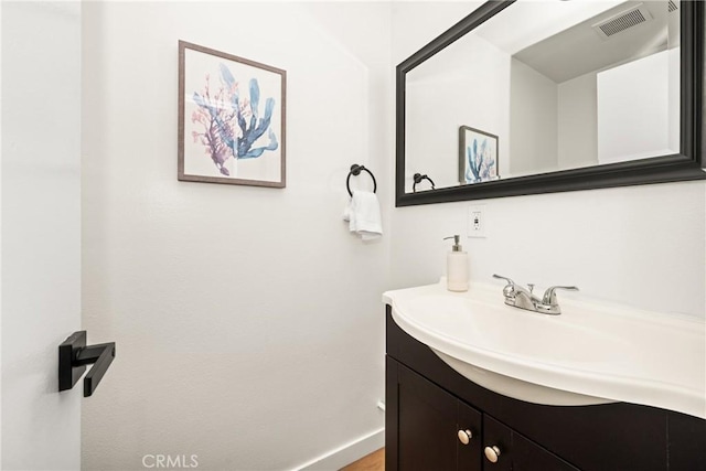 bathroom with vanity, baseboards, and visible vents