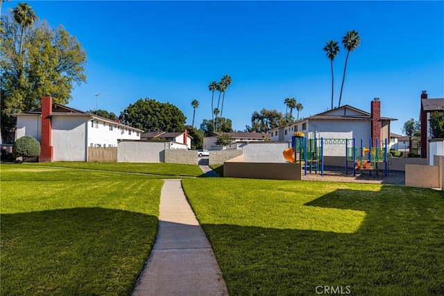 view of yard with fence and playground community