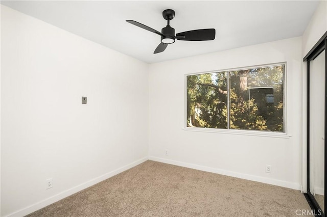 spare room with baseboards, carpet floors, and ceiling fan