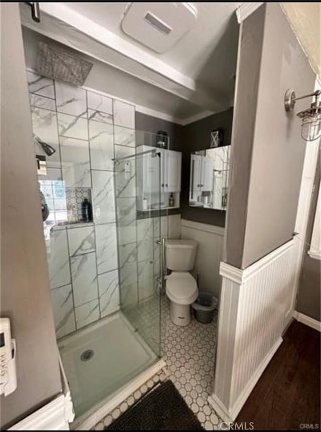 bathroom with walk in shower and toilet